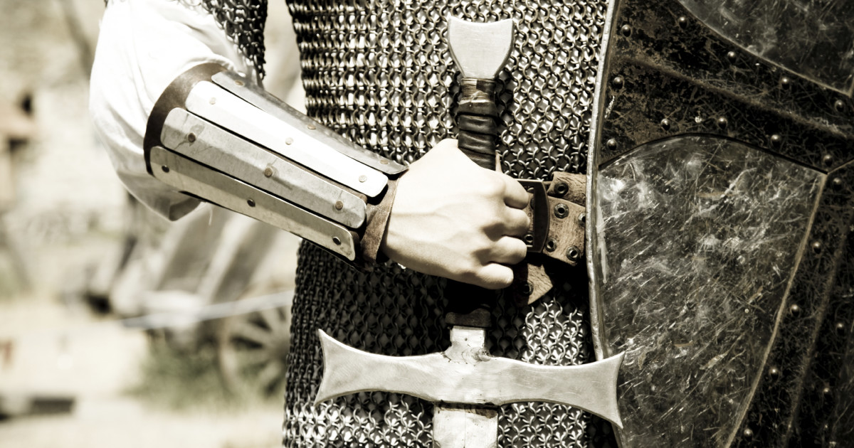 Man in suit of armor with medieval sword